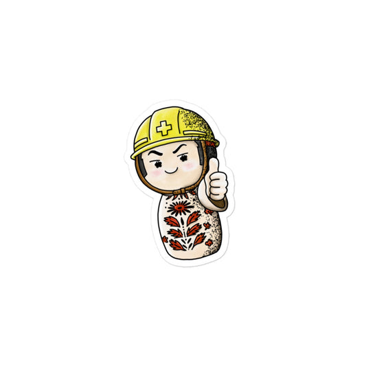Playful JapPop sticker of a Japanese Kokeshi doll wearing a helmet inspired by traditional wooden dolls