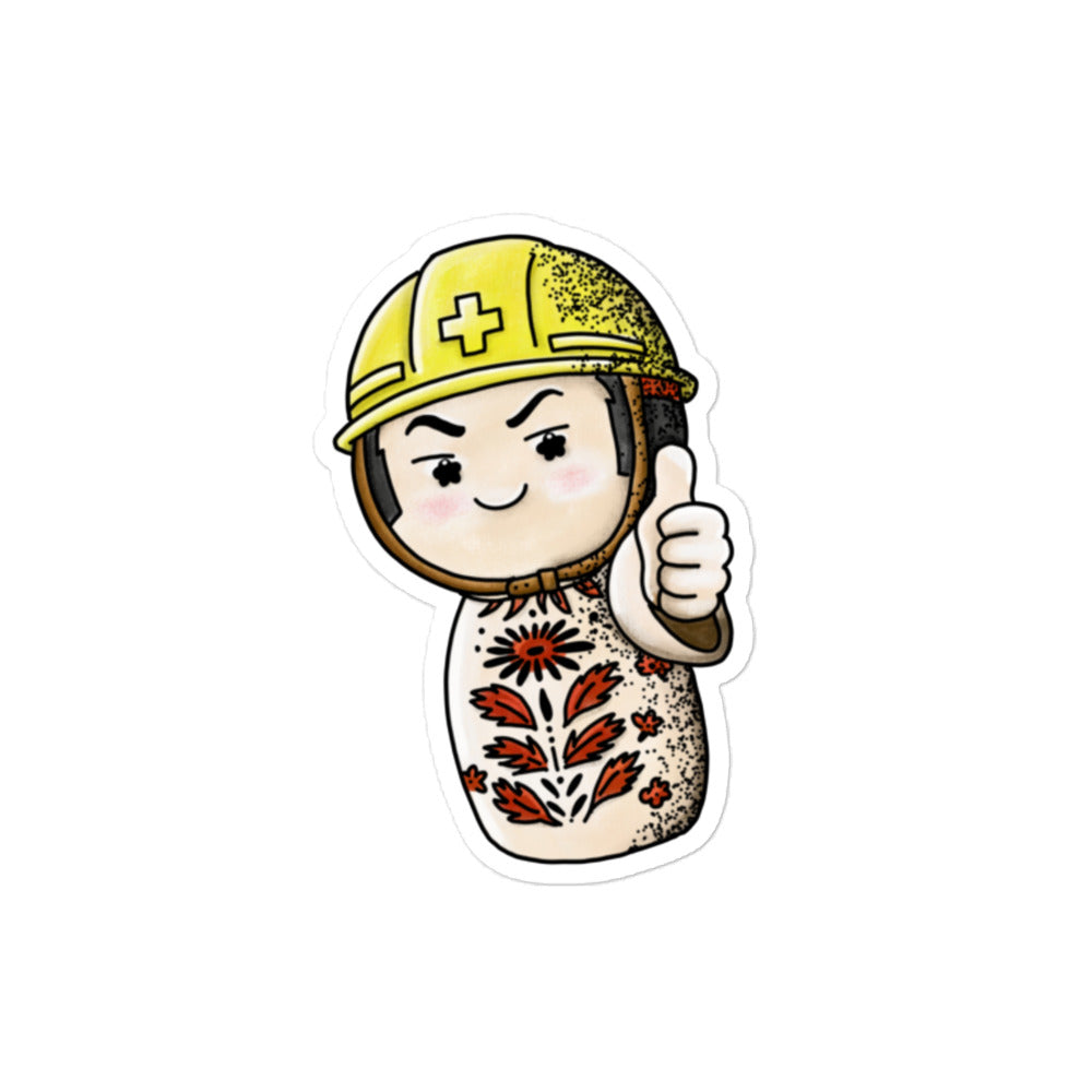 Playful JapPop sticker of a Japanese Kokeshi doll wearing a helmet inspired by traditional wooden dolls