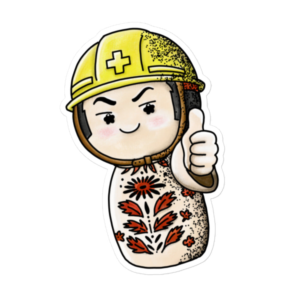 Playful JapPop sticker of a Japanese Kokeshi doll wearing a helmet inspired by traditional wooden dolls