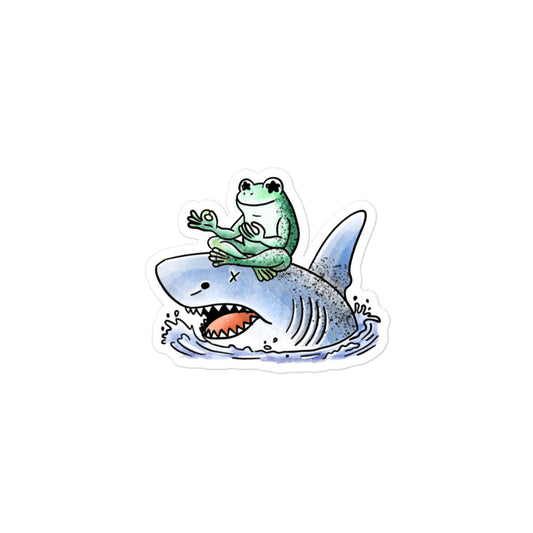 Stillness sticker illustration featuring a calm meditating frog resting on a shark, expressing balance and quiet contrast in JapPop style.